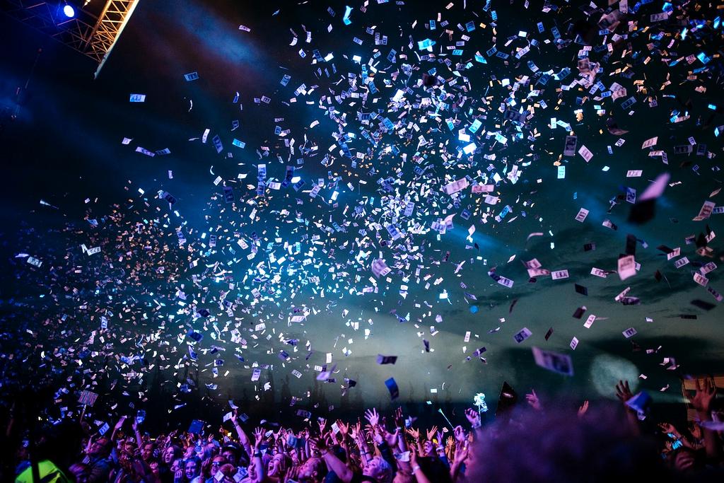 Live concert performance with dramatic stage lighting